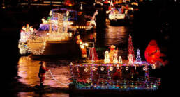 Boats decorated with Christmas lights during the San Diego Parade of Lights holiday boat parade.